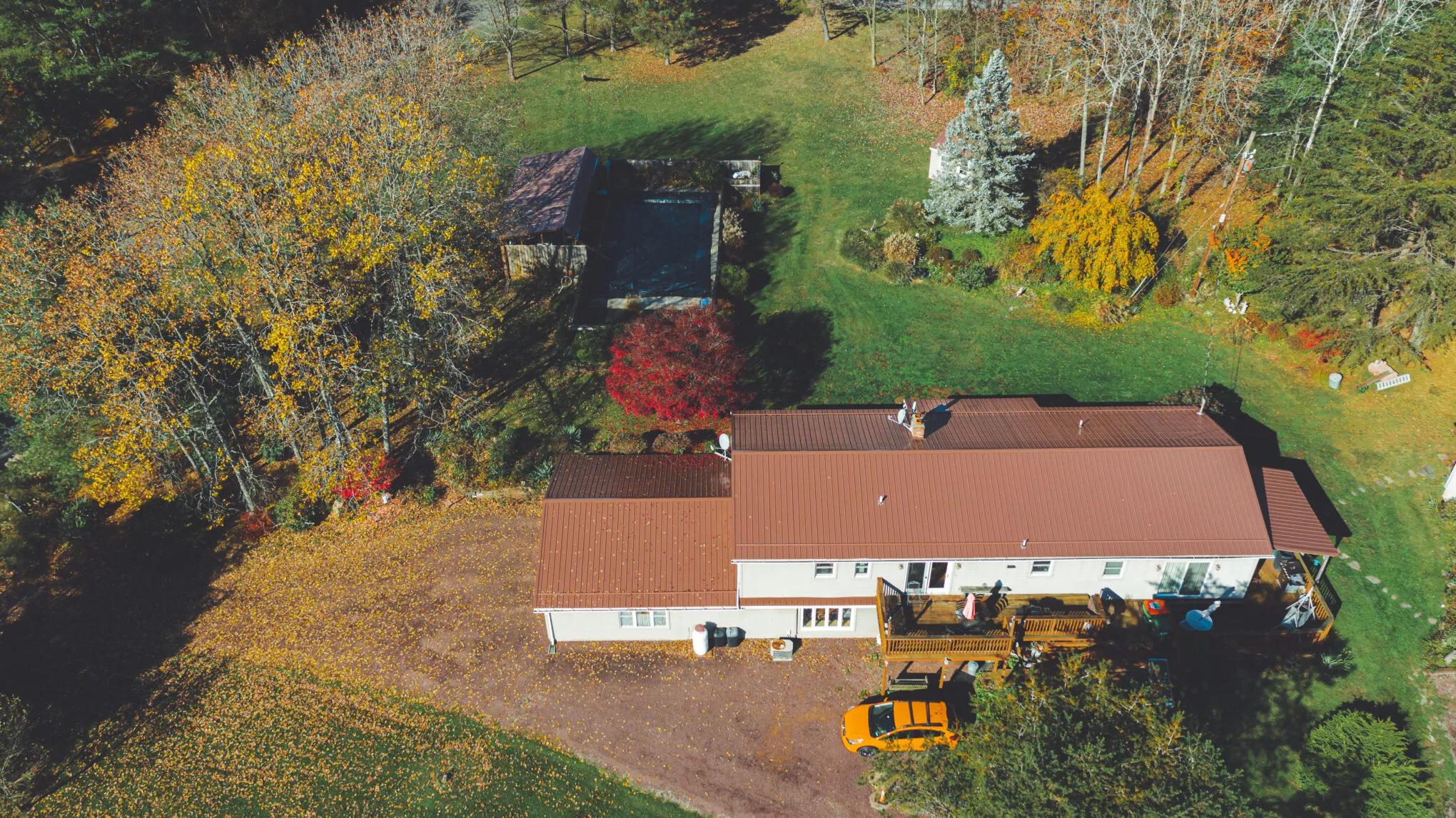 Aerial view of a residential metal roof replacement in progress
