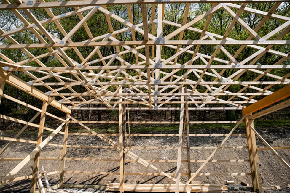 A barndominium under construction showing the post-frame shell